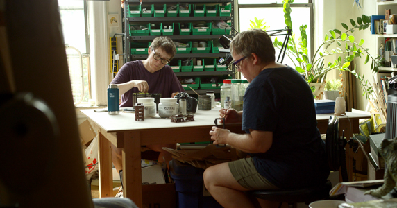 artists lori nix and kathleen gerber working together at a table